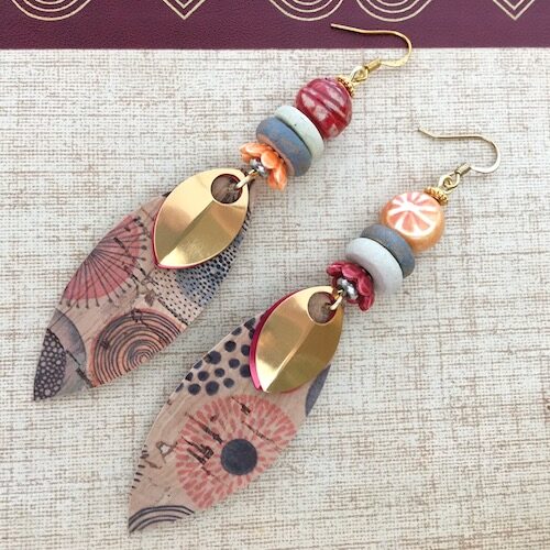 Red and orange gently asymmetrical earrings with petal shaped drops